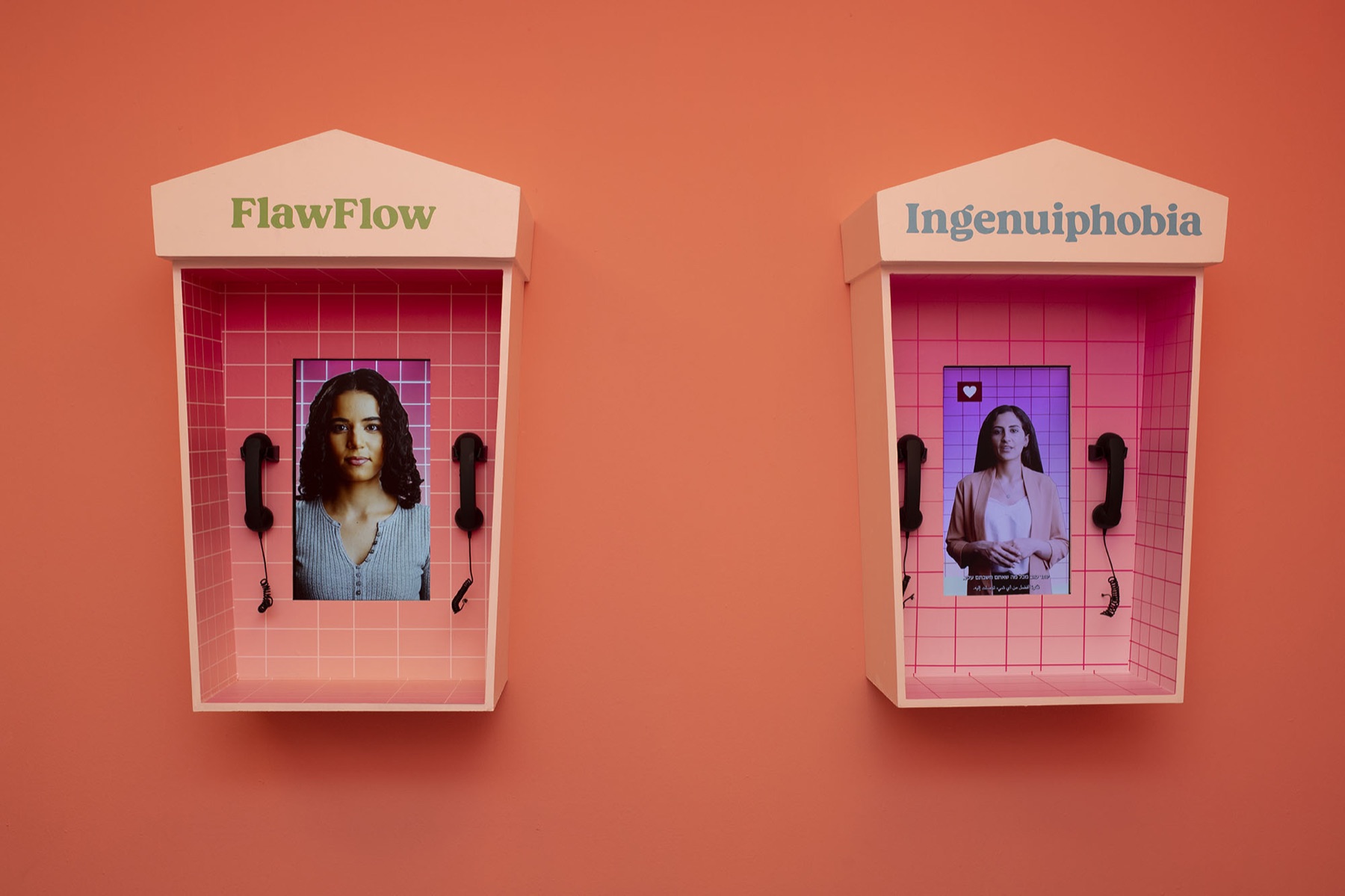 The FlawFlow and Ingenuiphobia booths side by side on the coral wall, handsets waiting